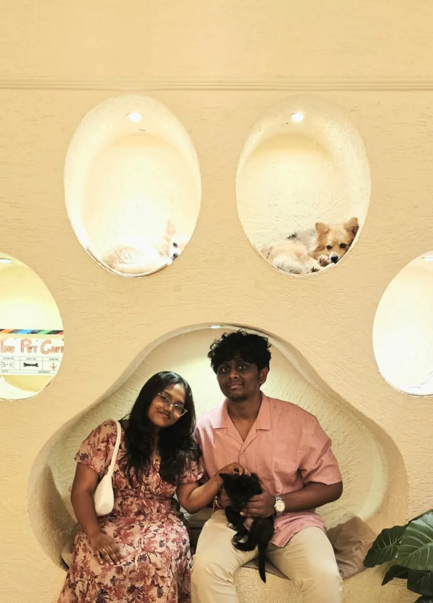 Us at The Pet Café, sitting inside the giant paw